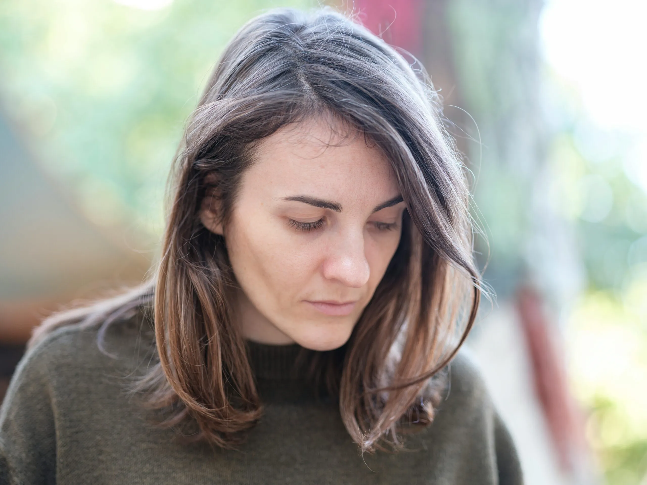 Person sitting in quiet reflection representing the painful question of love and shame after infidelity