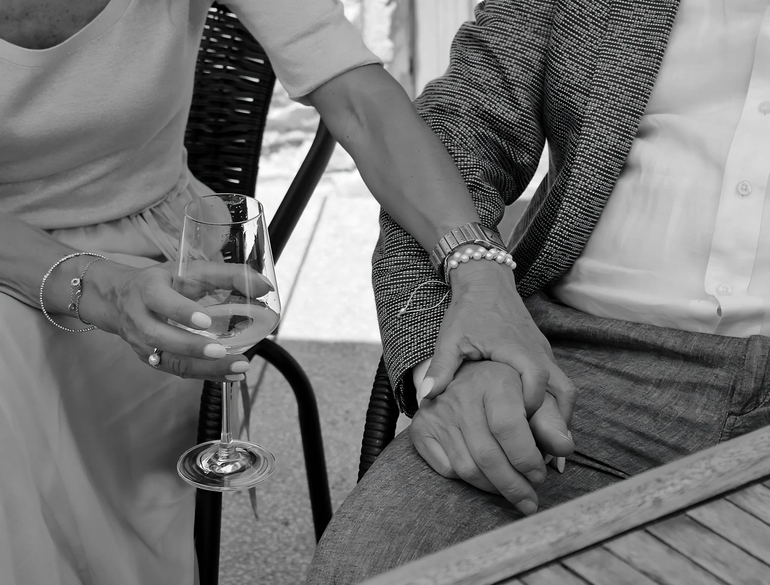 Couple holding hands over a dinner table representing emotional and physical connection and relationship compatibility