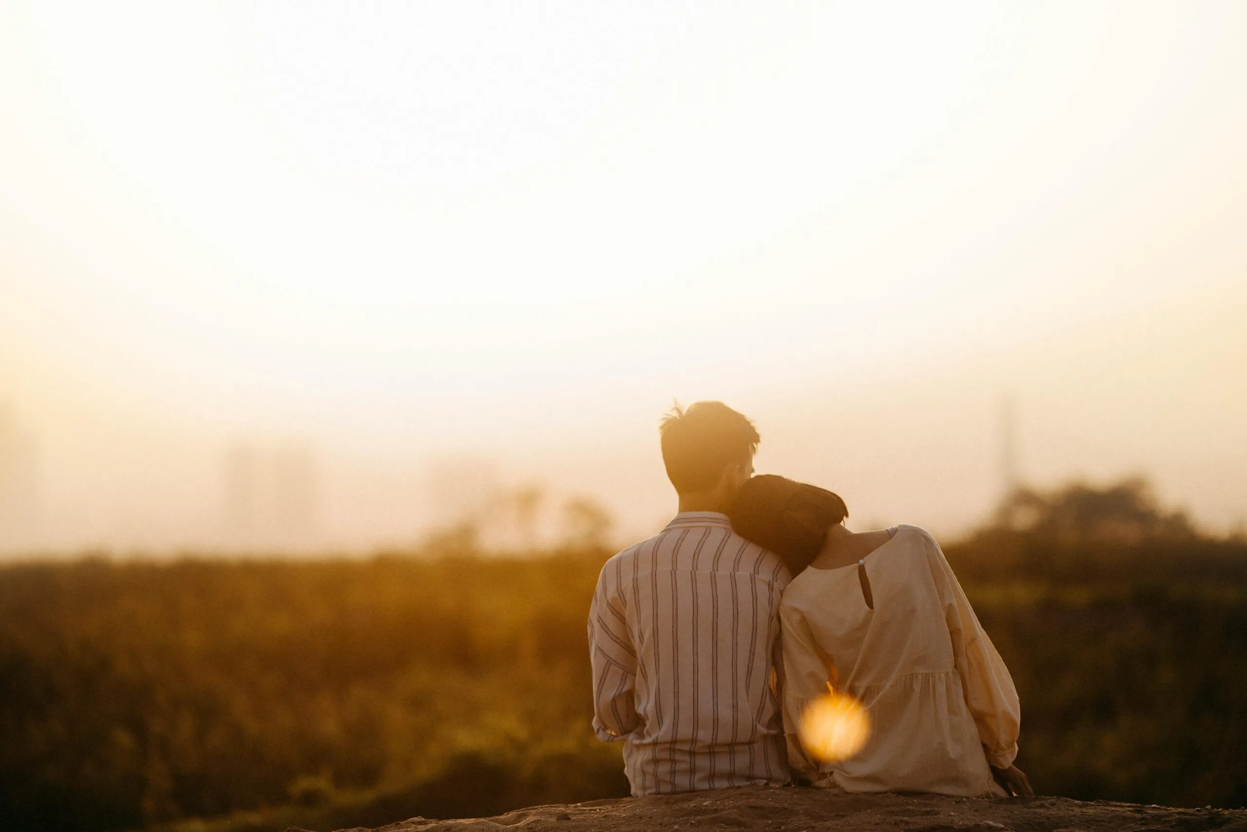 Couple sharing a quiet moment at sunset representing hope and emotional reconnection after betrayal trauma
