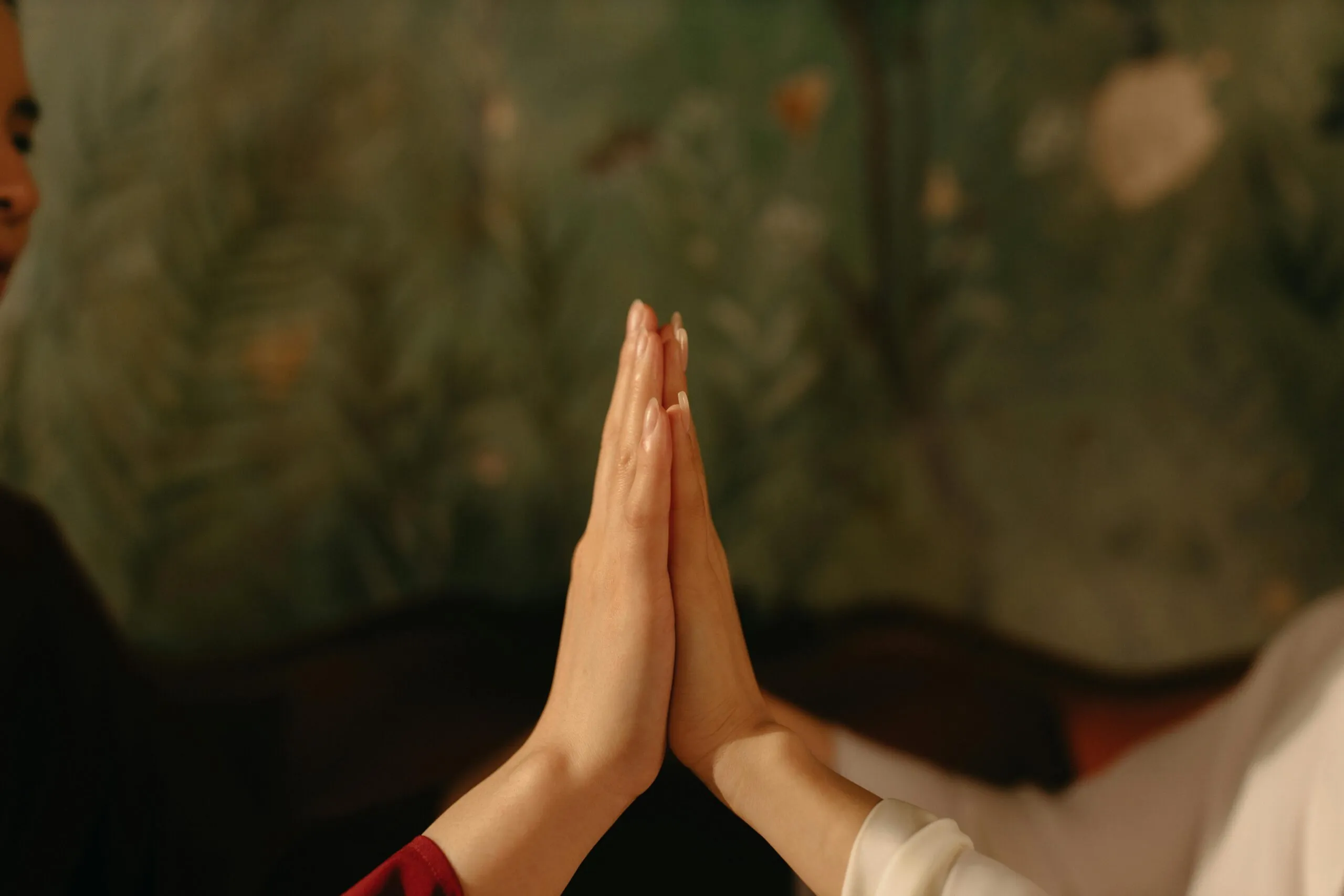 Two hands touching representing compromise and connection in a healthy relationship