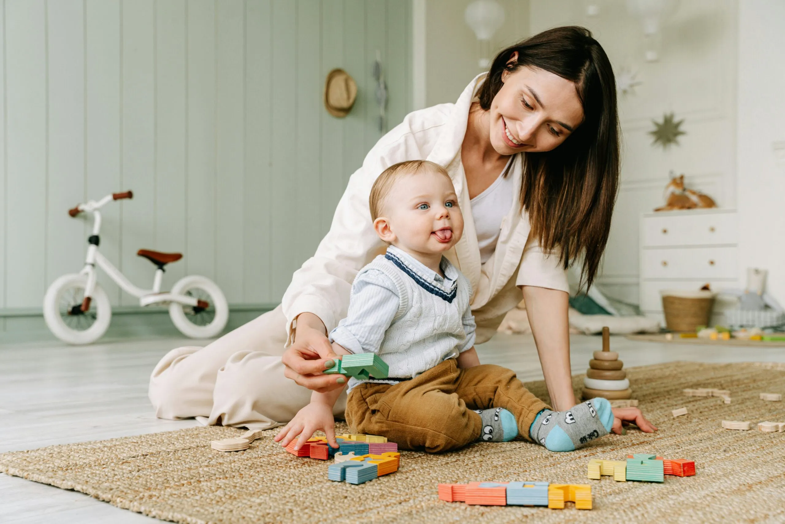 Mother playing with her baby representing the connection between inner healing and healthy family relationships