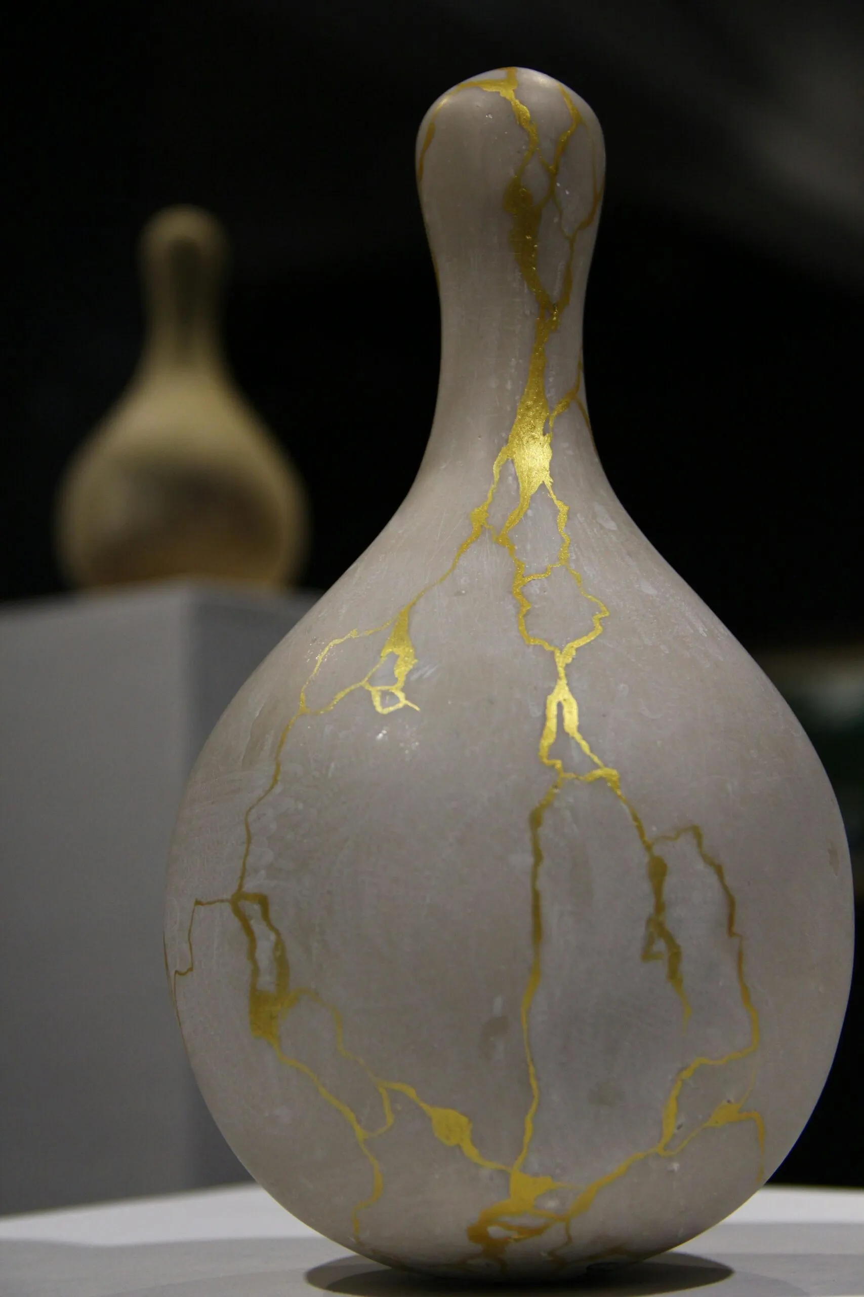 Close-up of a Kintsugi ceramic vase repaired with gold representing healing and beauty in sex addiction recovery
