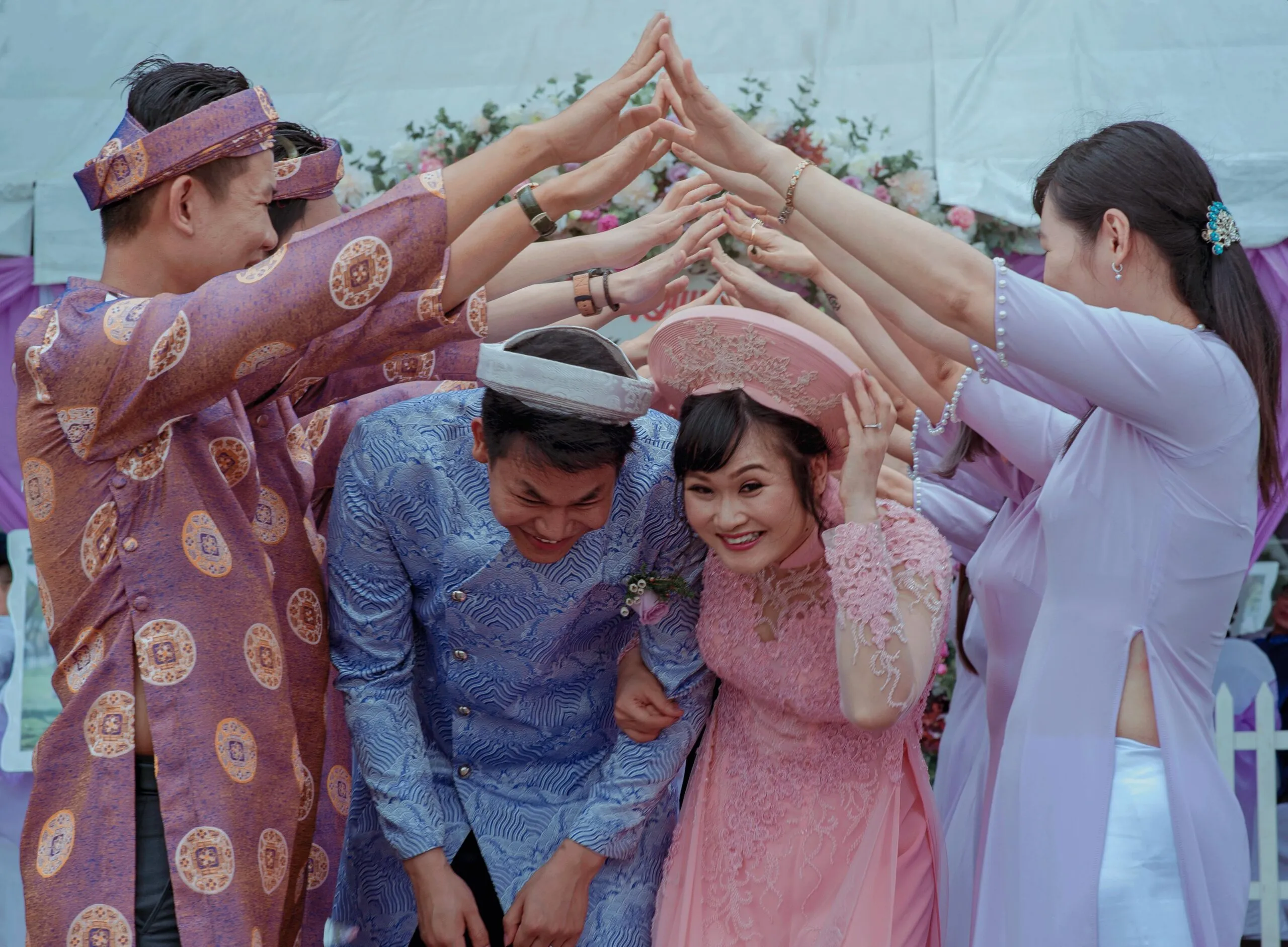 Couple celebrating their wedding surrounded by family representing the joy and complexity of navigating in-law relationships
