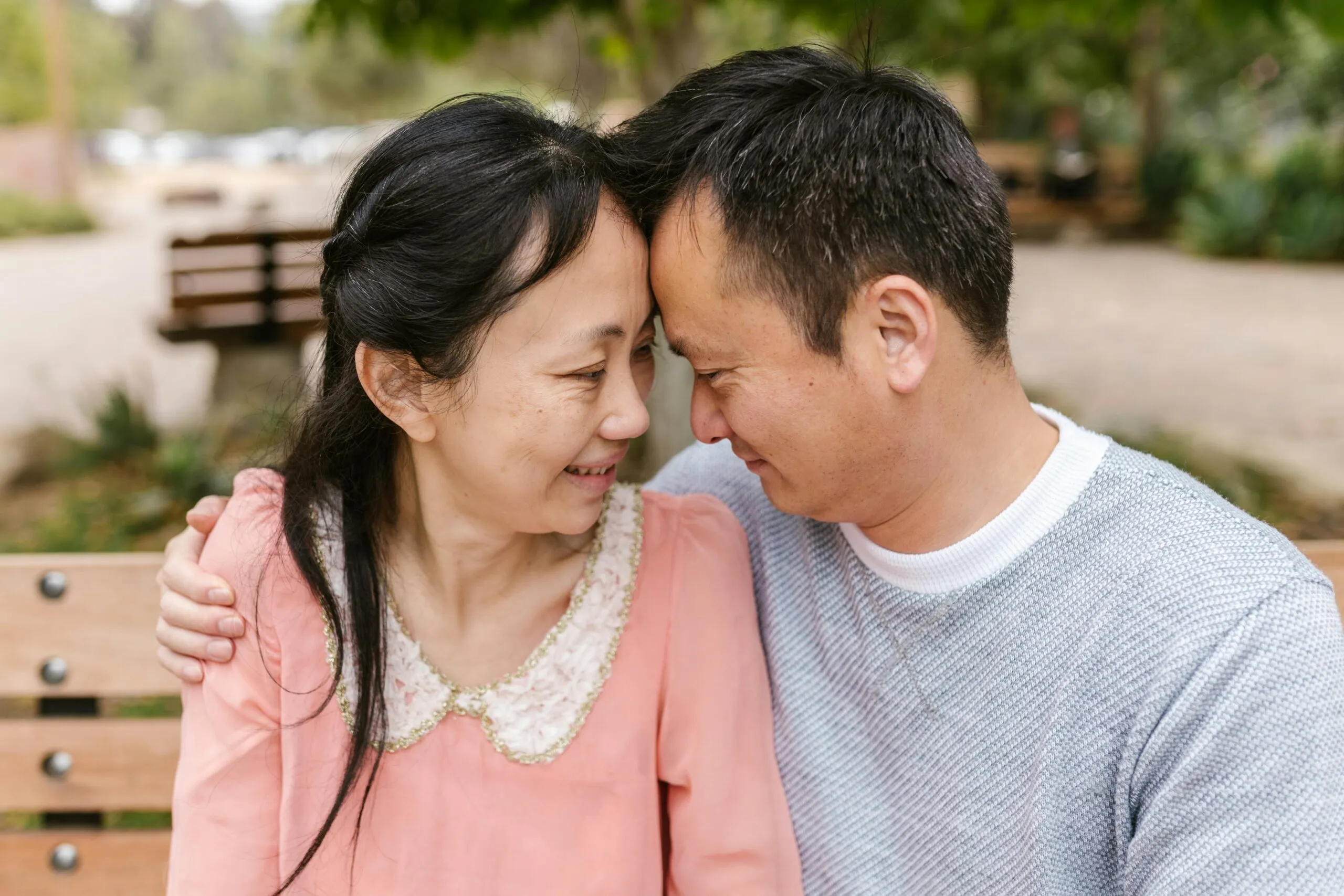 Smiling couple embracing outdoors representing connection and hope in a neurodiverse relationship