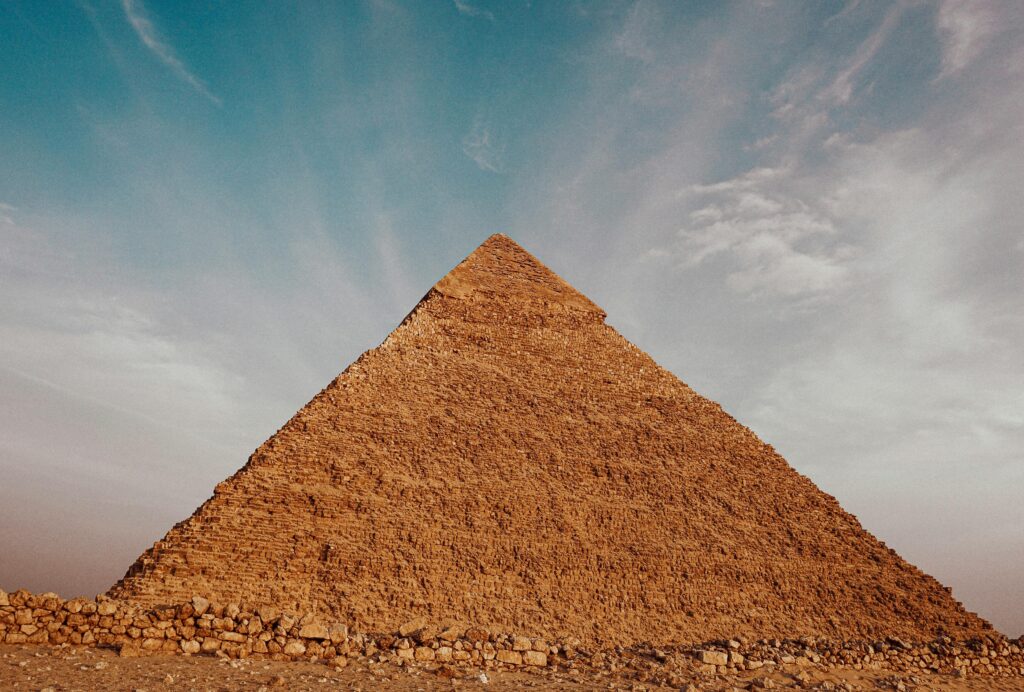 Majestic view of the Great Pyramid in Cairo, showcasing ancient architecture under a clear sky.