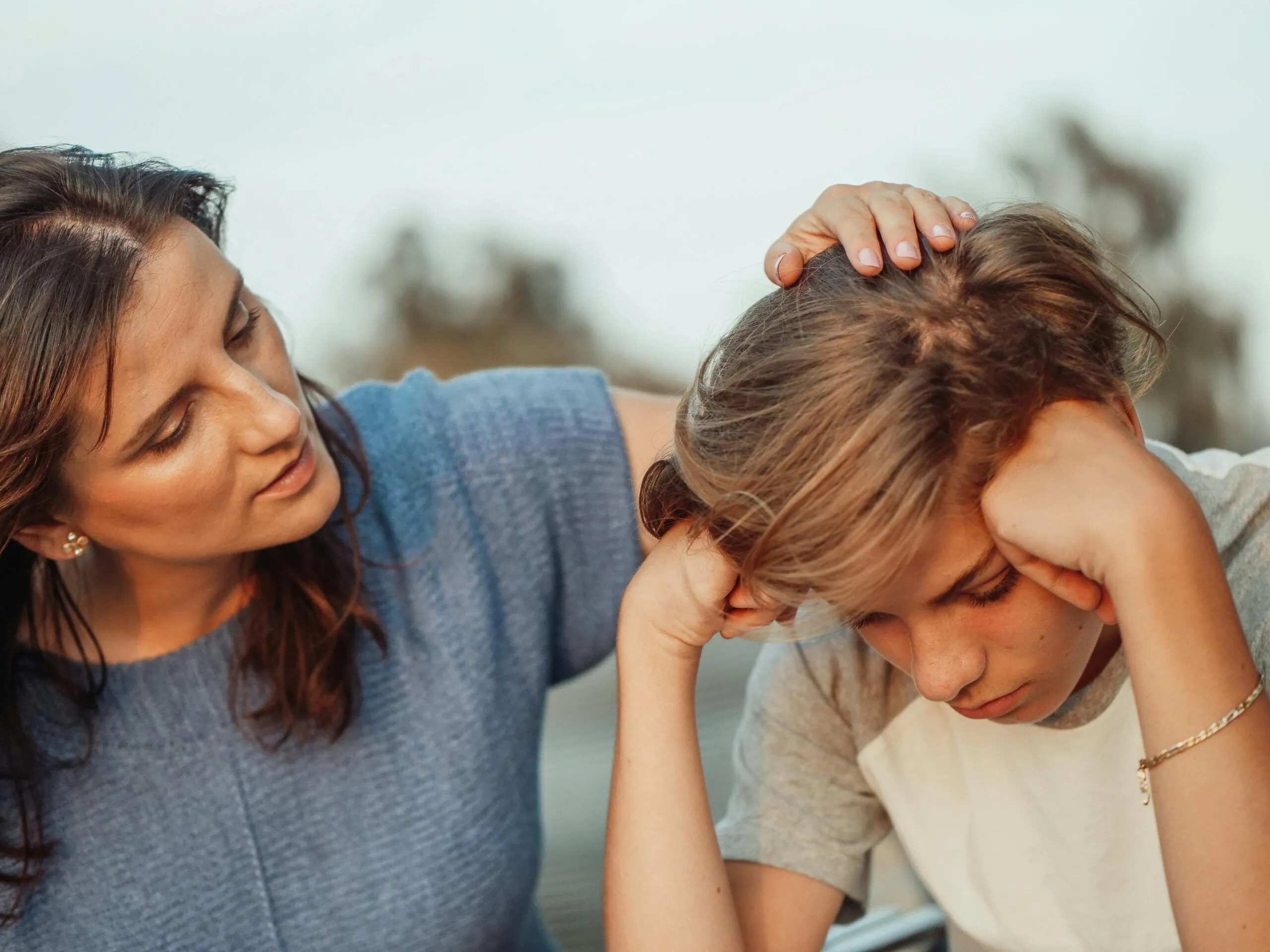 Mother offering compassionate support to her son representing trauma-informed communication in relationships