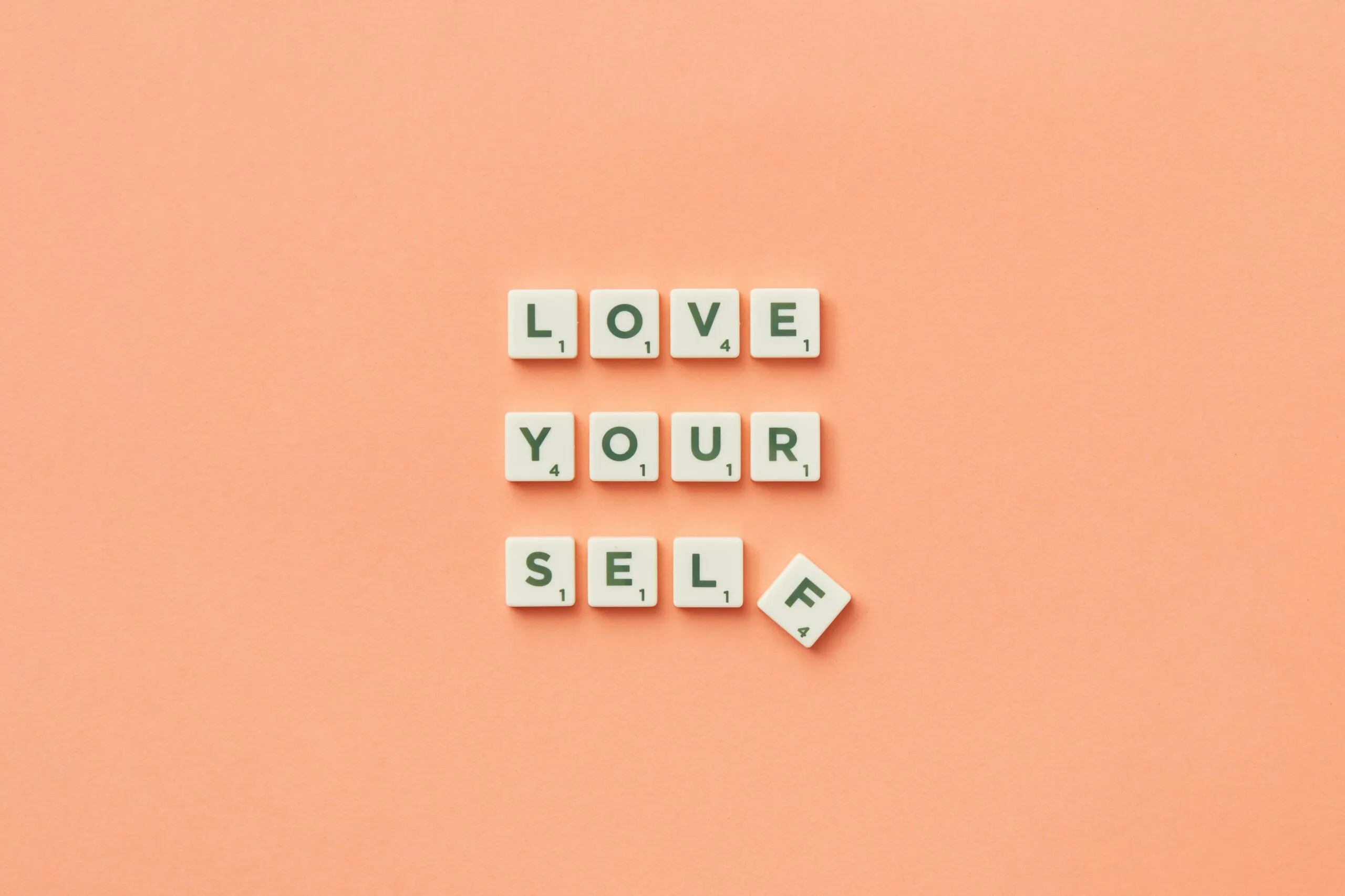 Scrabble tiles spelling Love Yourself — IFS therapy for sexual compulsivity recovery in Utah