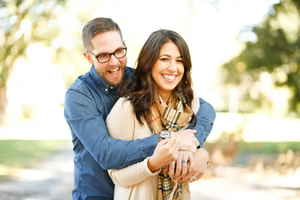 Couple smiling together outdoors after rebuilding trust through couples therapy in Utah