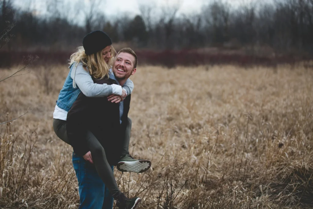 Happy couple enjoying a playful moment outdoors representing healthy communication and connection in relationships