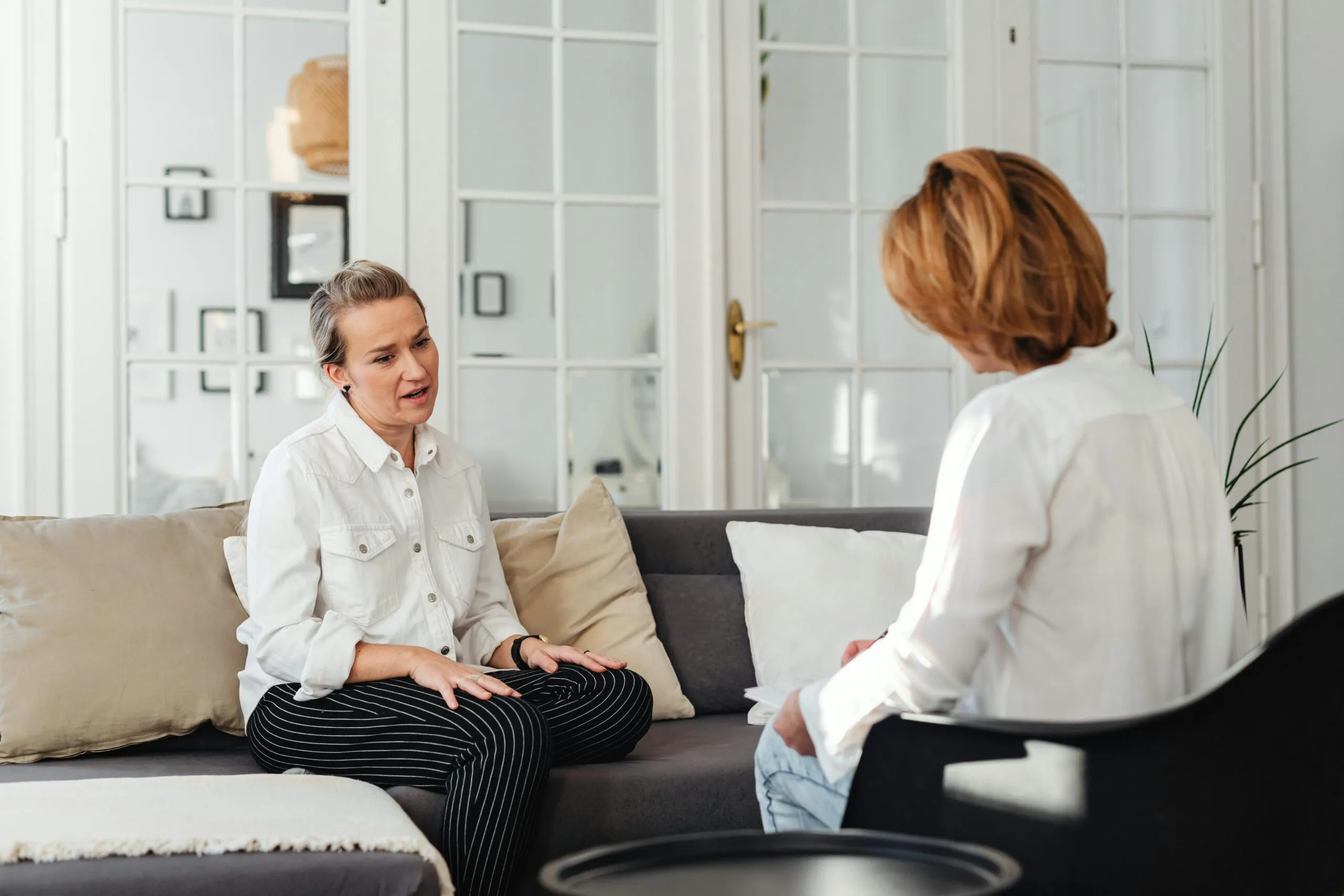 Woman sitting alone in emotional distress during a counseling session
