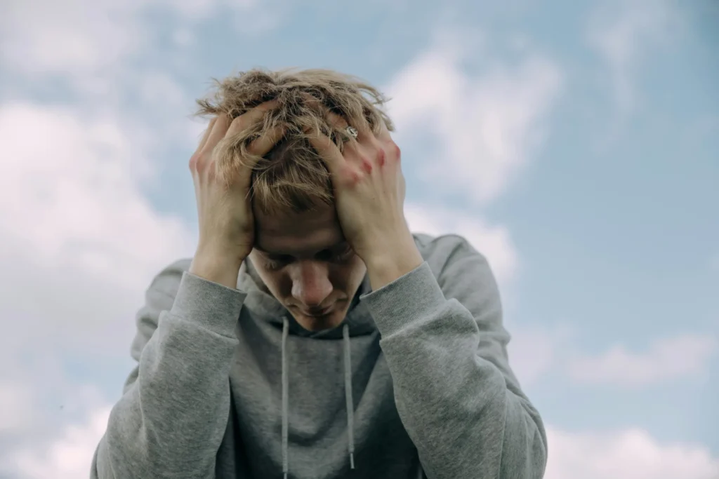 Man in gray hoodie experiencing frustration during pornography addiction recovery in Utah