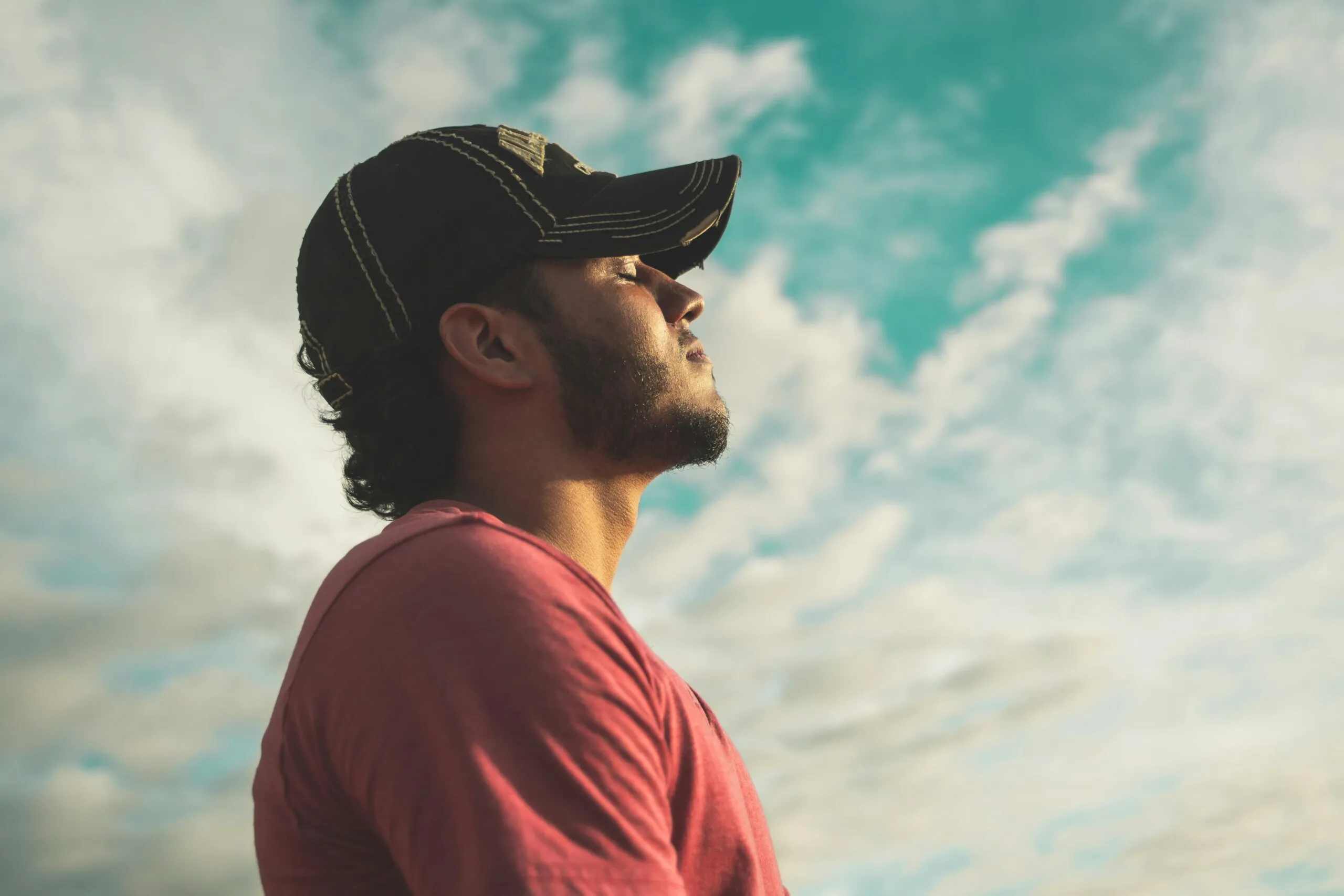 Man deep breathing and reflecting in nature during a moment of emotional regulation